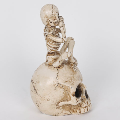 3.0*3.5*6.75'' Resin Covering Mouth Skeleton Sitting On Skull Décor W/Lite
